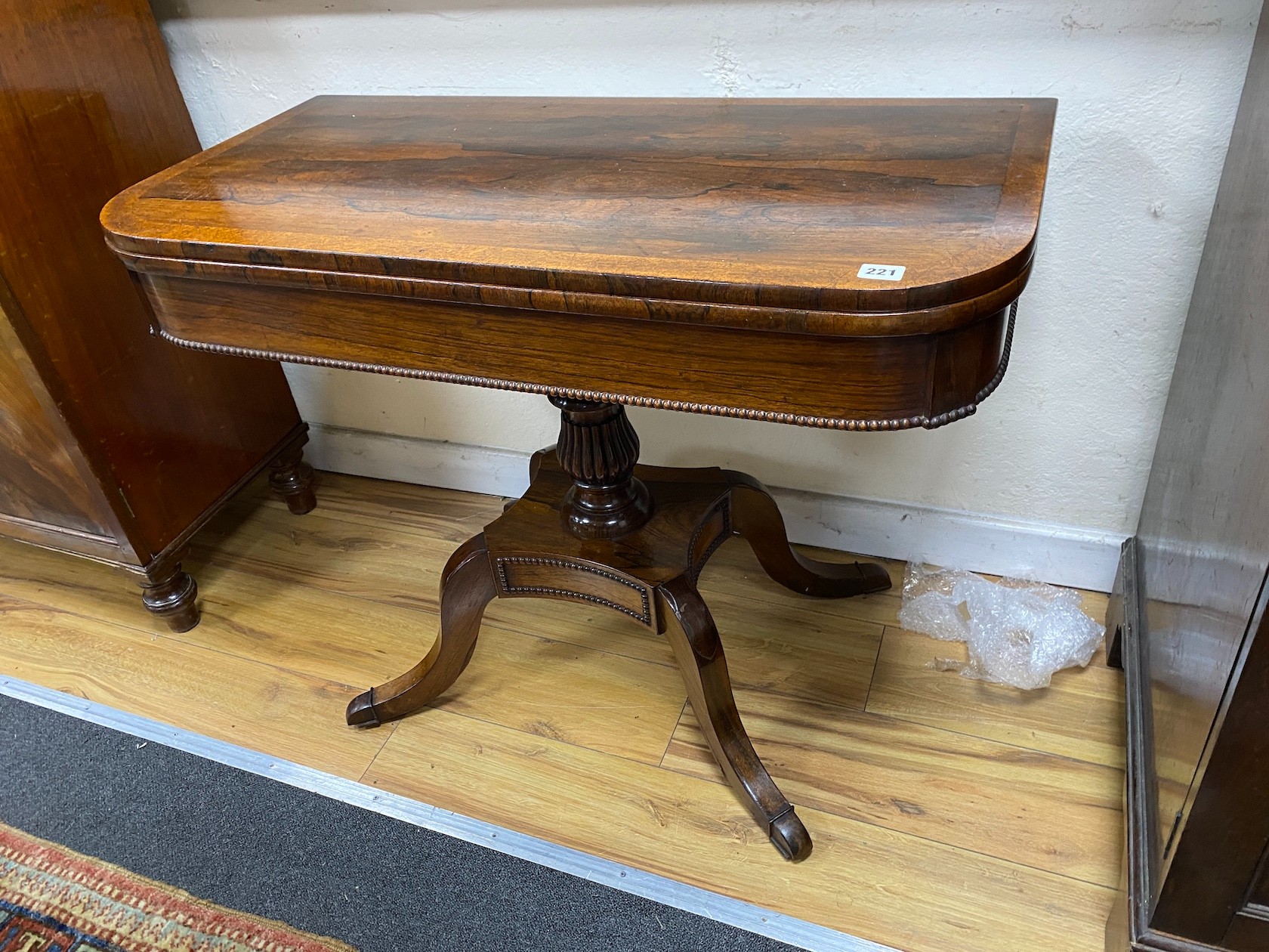 A Regency amboyna banded rosewood D shape folding card table, width 92cm, depth 46cm, height 72cm